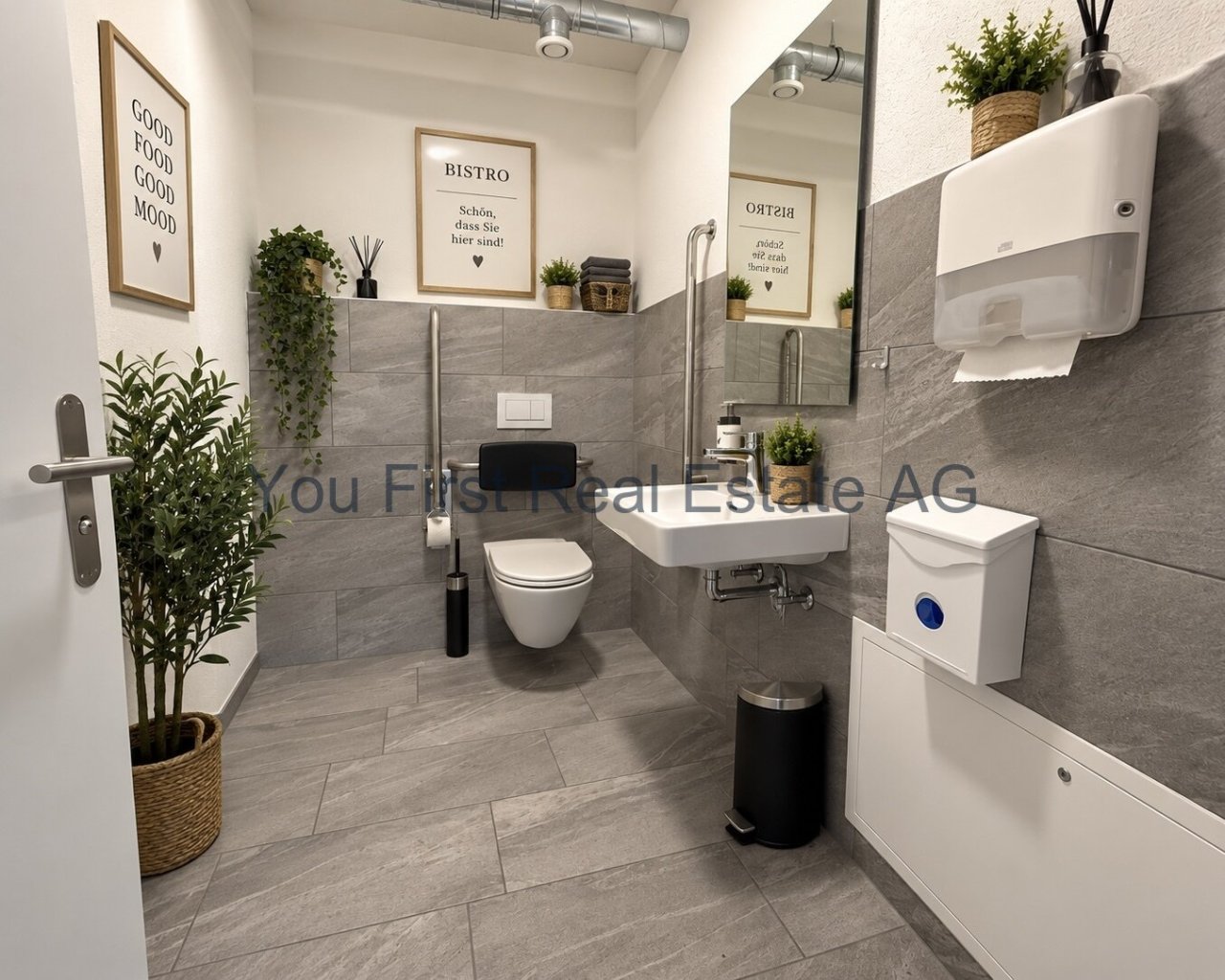 Modernes, barrierefreies Gäste-WC mit hochwertiger Fliesenausstattung und funktionaler Sanitäreinrichtung.