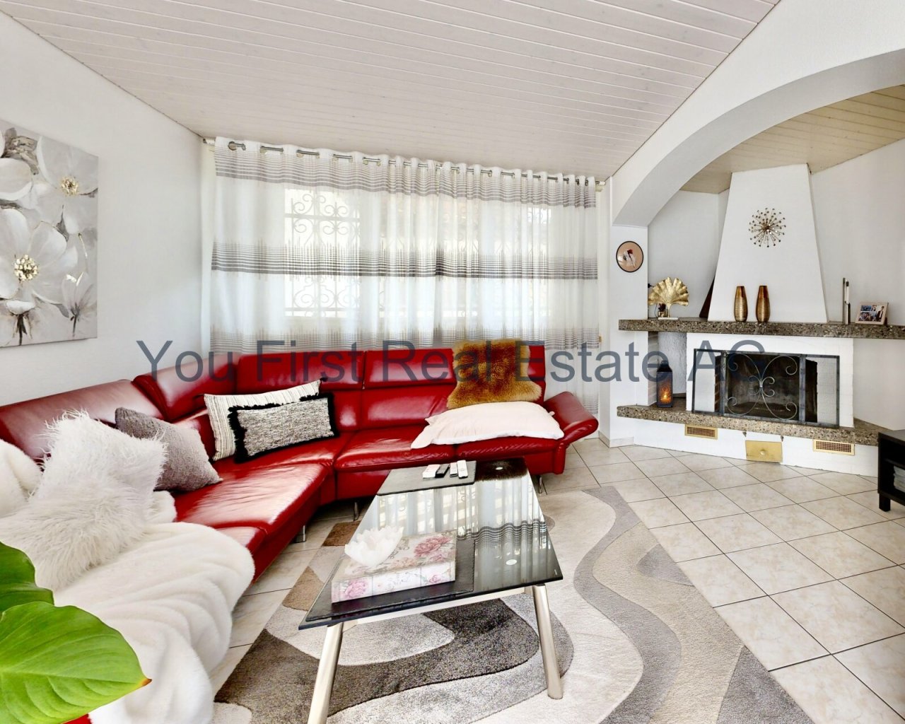 Wohnzimmer mit Kaminanlage, Spitzbogenfenster und offener Raumgestaltung
