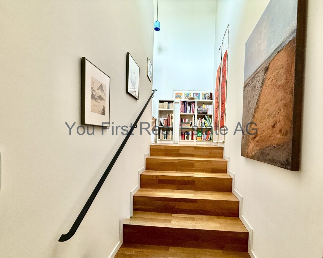 Designtreppe mit integriertem Bücherregal - Clevere Raumnutzung mit Holzakzenten und moderner Geländerführung